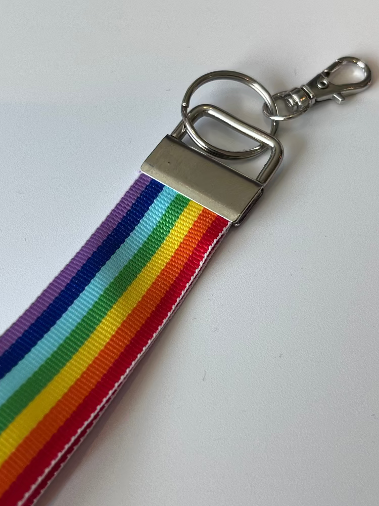 Rainbow striped keychain with metal clasp on a white background
