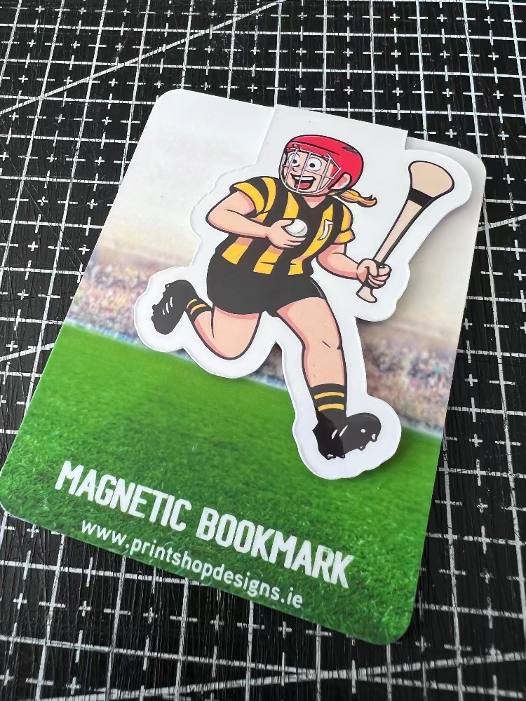 Magnetic bookmark with cartoon character on a sports field, on a grid background