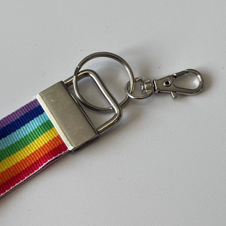 Keychain with rainbow ribbon and metal clasp on a white background