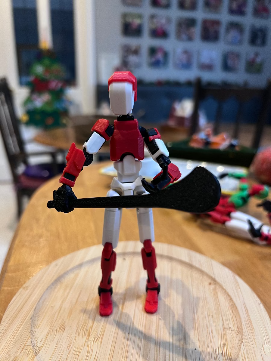 Toy figure with red and white design on a wooden surface