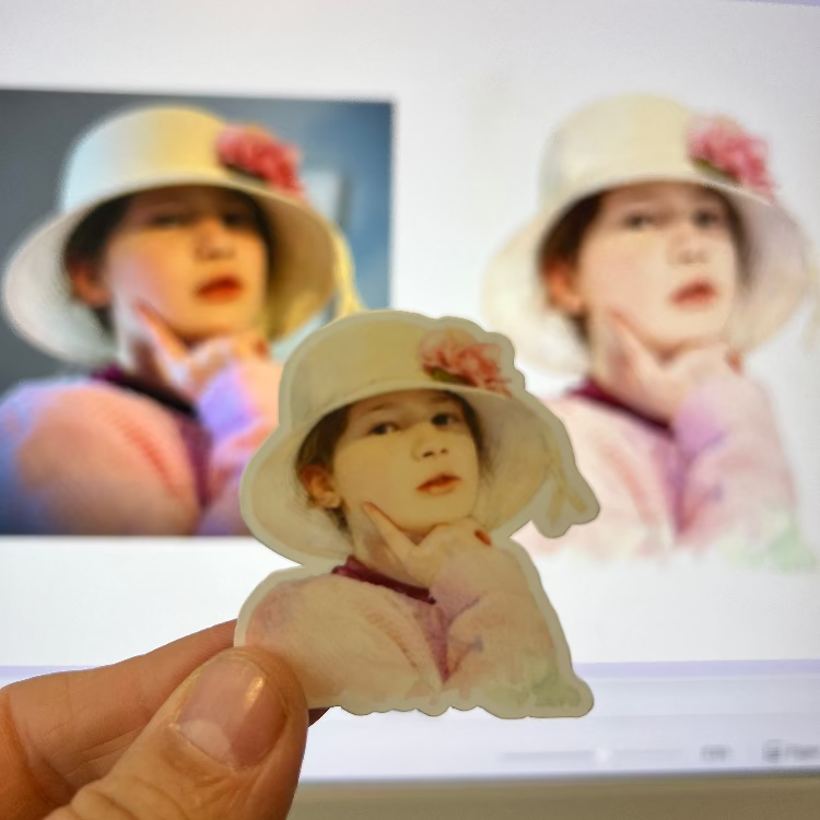 Small cutout of a child wearing a hat with a blurred background