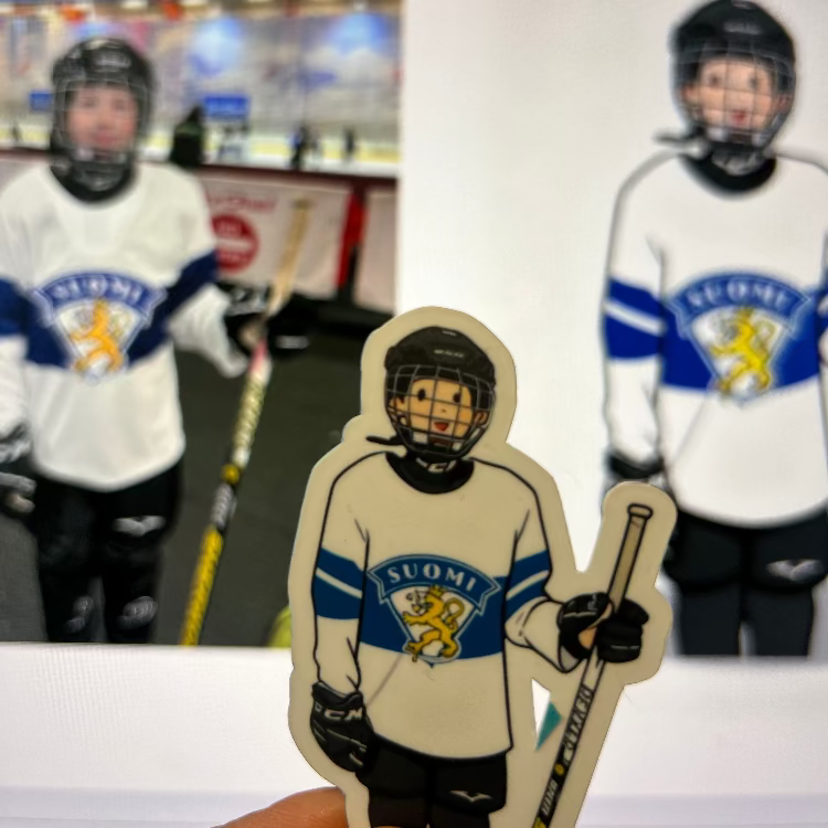 Hockey player cutout with 'Suomi' jersey in front of blurred hockey players and equipment.