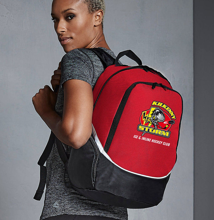 Person wearing a red and black backpack with a logo on a gray background