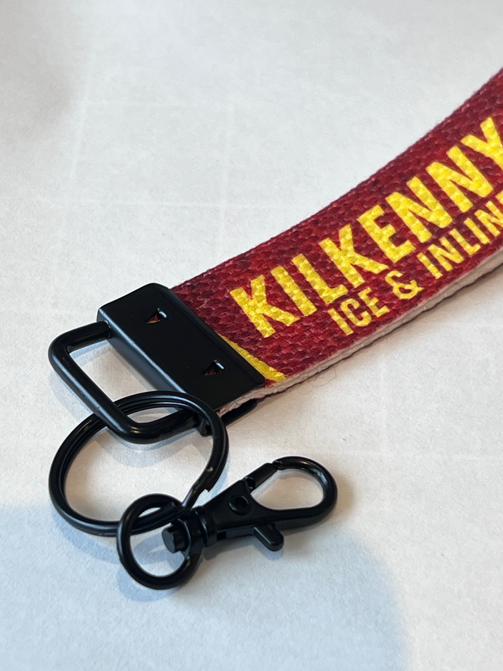 Keychain with 'Kilkenny Ice & Inline' text on a red strap against a white background