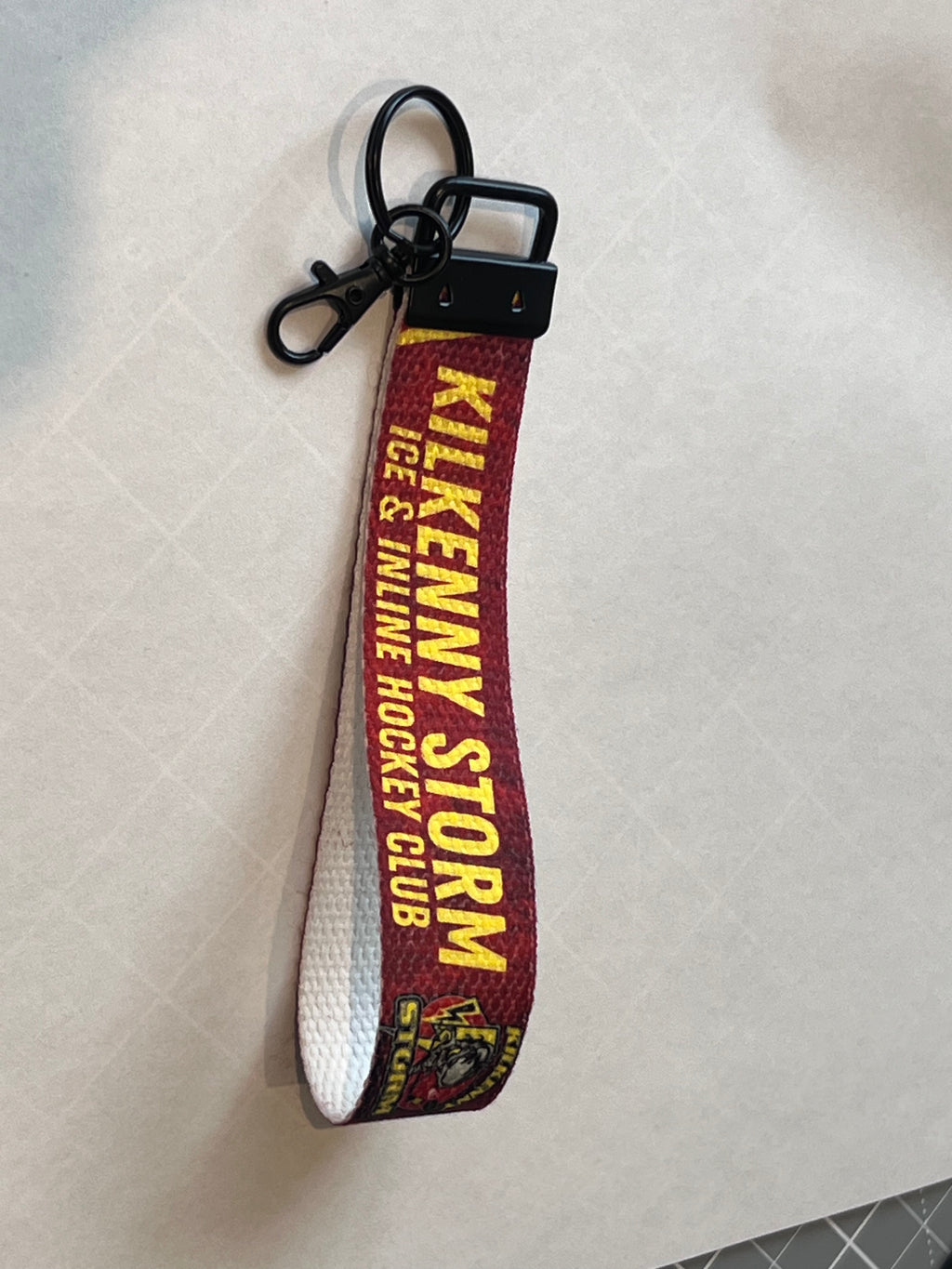 Keychain with 'Kilkenny Storm' text on a white background