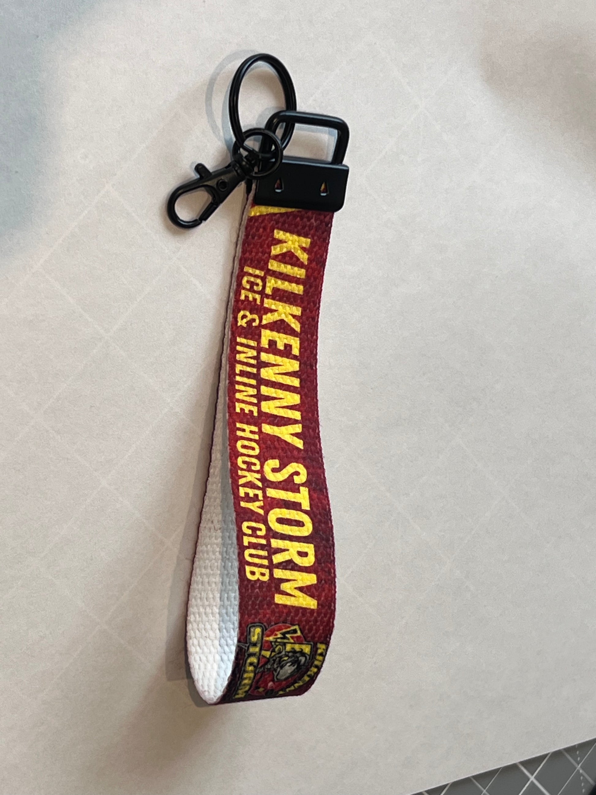 Keychain with 'Kilkenny Storm' text on a white background