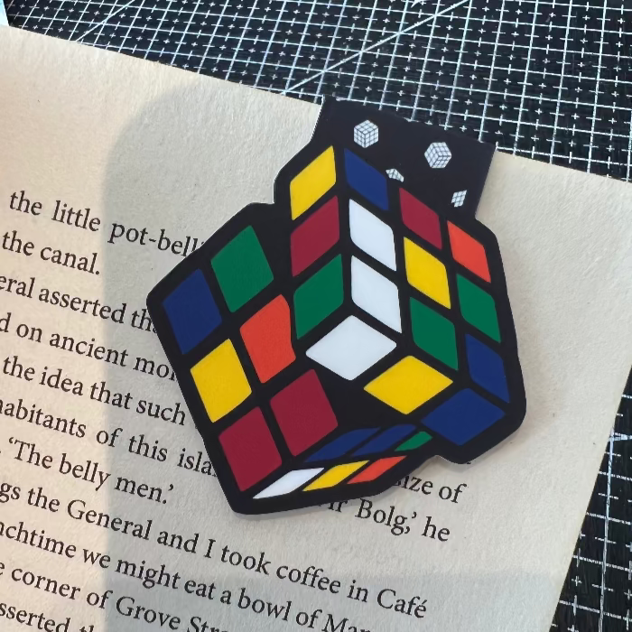 Rubik's Cube-shaped patch on a piece of paper with text