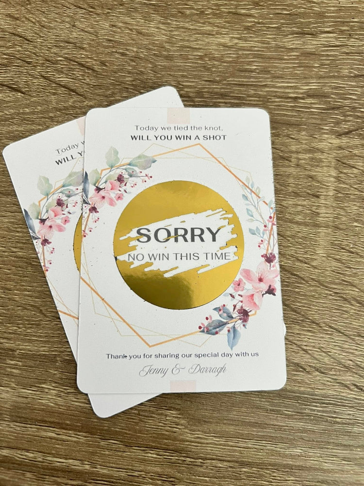 Two cards with floral designs and text on a wooden surface