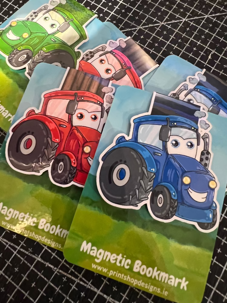 Set of colorful magnetic bookmarks with cartoon designs on a black grid background.