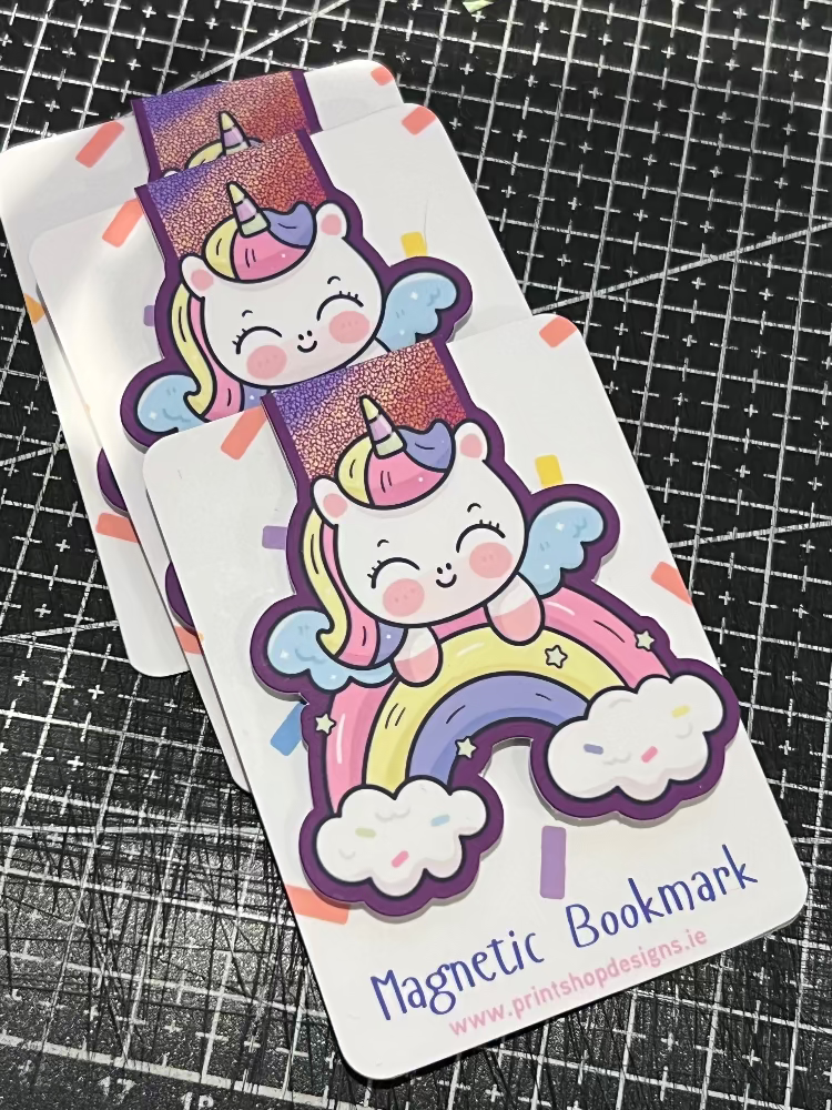 Unicorn-themed magnetic bookmark on a grid background