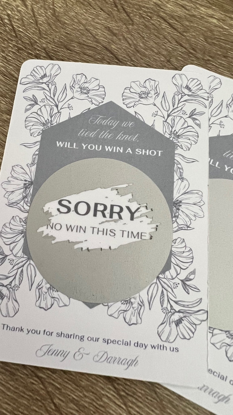 Card with floral design and text on a wooden surface