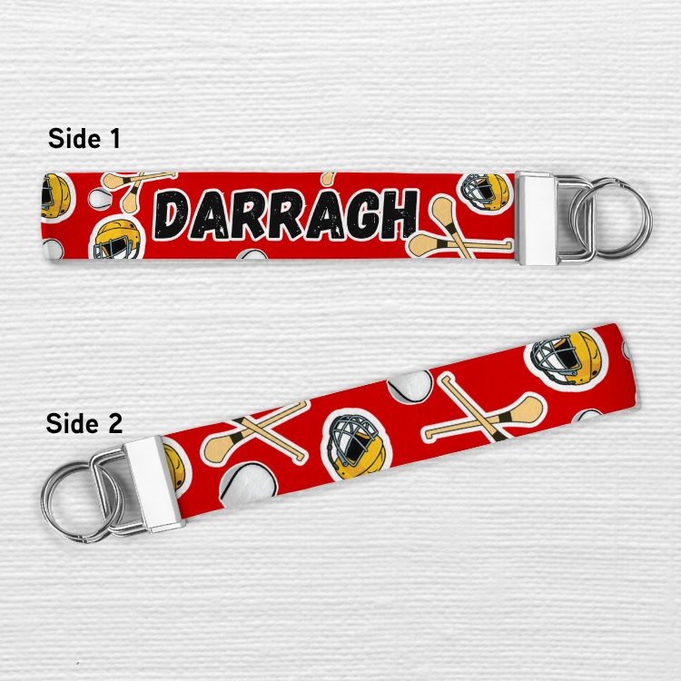 Keychain with 'DARRAGH' on a red background with sports-themed designs